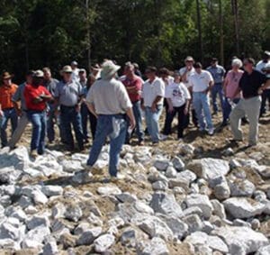 a group of people standing on a rock