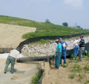 a group of people walking down a dirt road